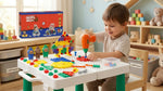 Unboxed contents: table with legs, drill, tools, plates, screws, nuts, clips, 2 dolls