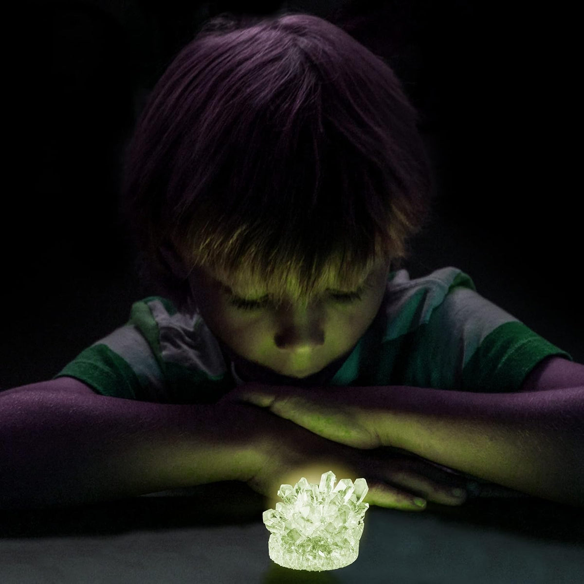Child using the glow-in-the-dark crystal growing kit