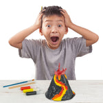 Child painting a volcano model from the science kit