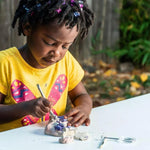 Child excavating a gemstone from the dig brick